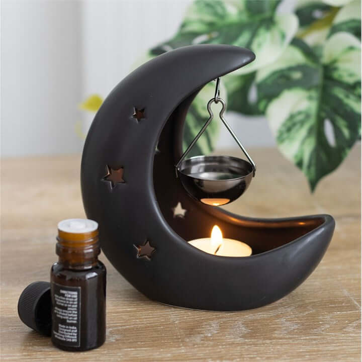 Black Crescent Moon Hanging Oil Burner with a suspended bowl and candle for a mystical fragrance ambience.