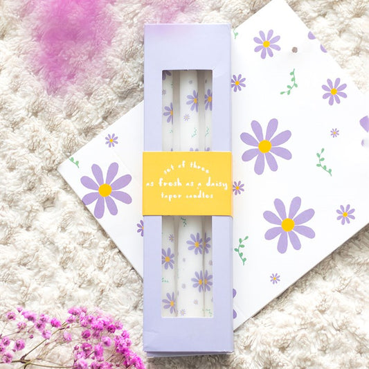 Set of 3 Purple Daisy Taper Candles - Unscented, perfect for spring decor and enhancing table settings.