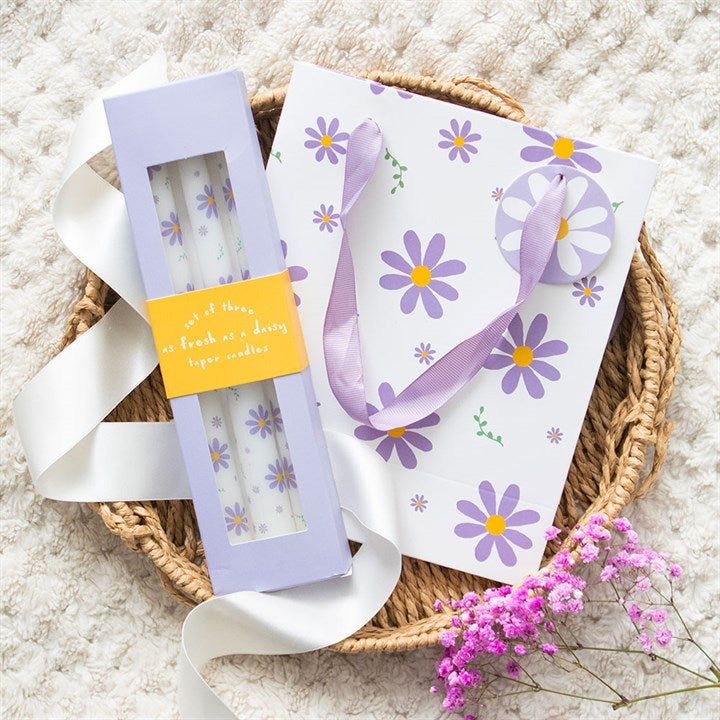 Set of 3 Purple Daisy Taper Candles - Unscented, perfect for spring decor and enhancing your table setting.