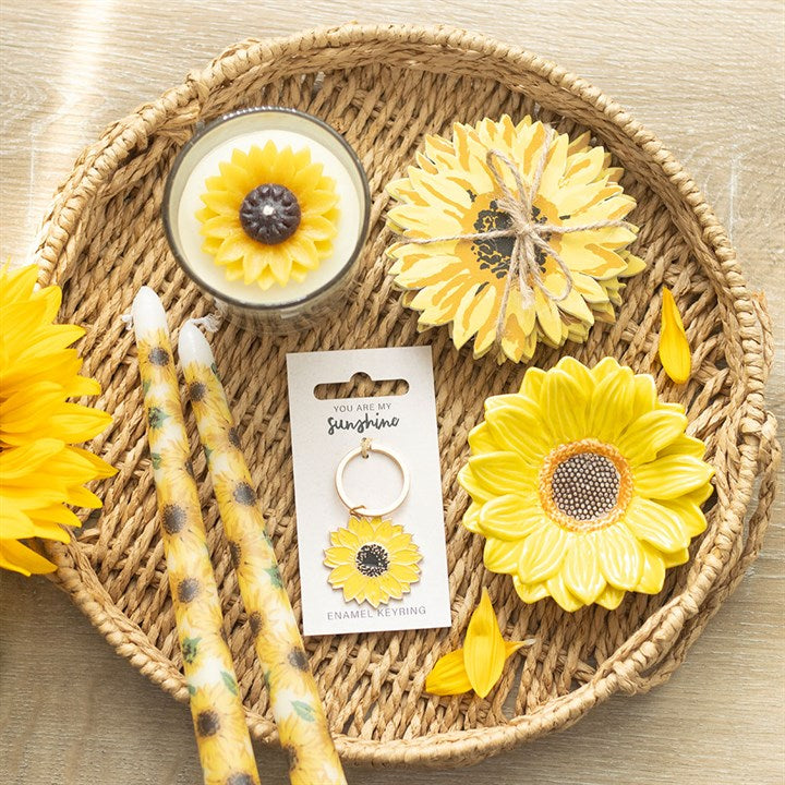Cheerful You Are My Sunshine Sunflower Keyring displayed with vibrant yellow flowers and candles, perfect for gifting.