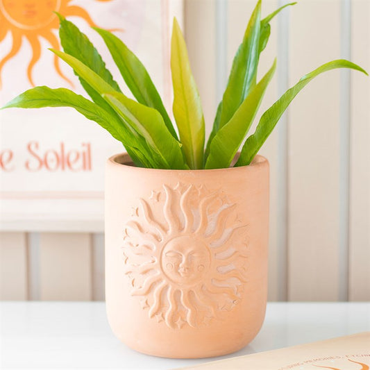 Stylish Terracotta Sun Plant Pot with embossed sun design, perfect for bohemian decor and showcasing your favourite plants.