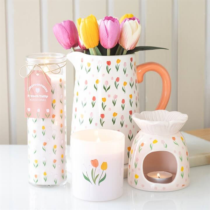 Hand Painted Tulip Print Ceramic Oil Burner And Wax Warmer with colorful tulips and candles on a table.