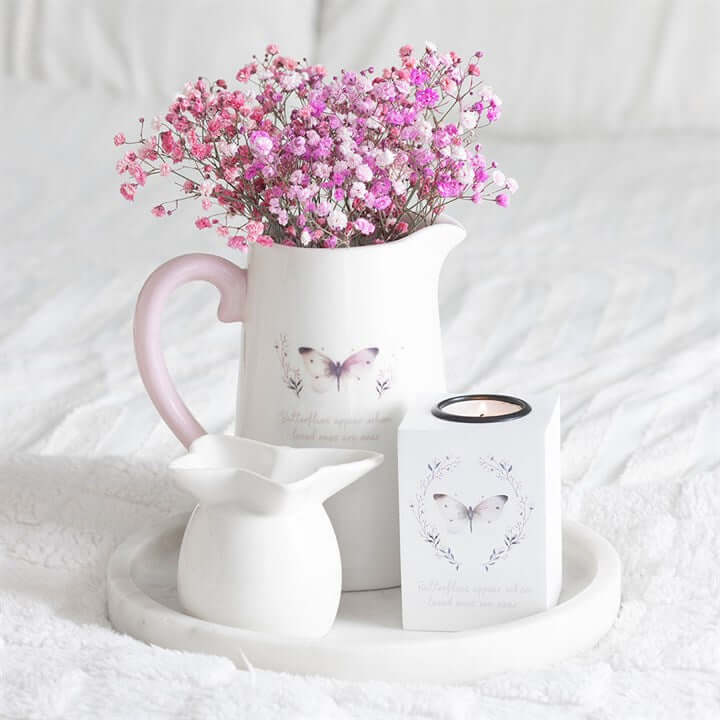 White Butterfly Print Ceramic Flower Jug With Heartfelt Message filled with pink flowers on a white aesthetic background