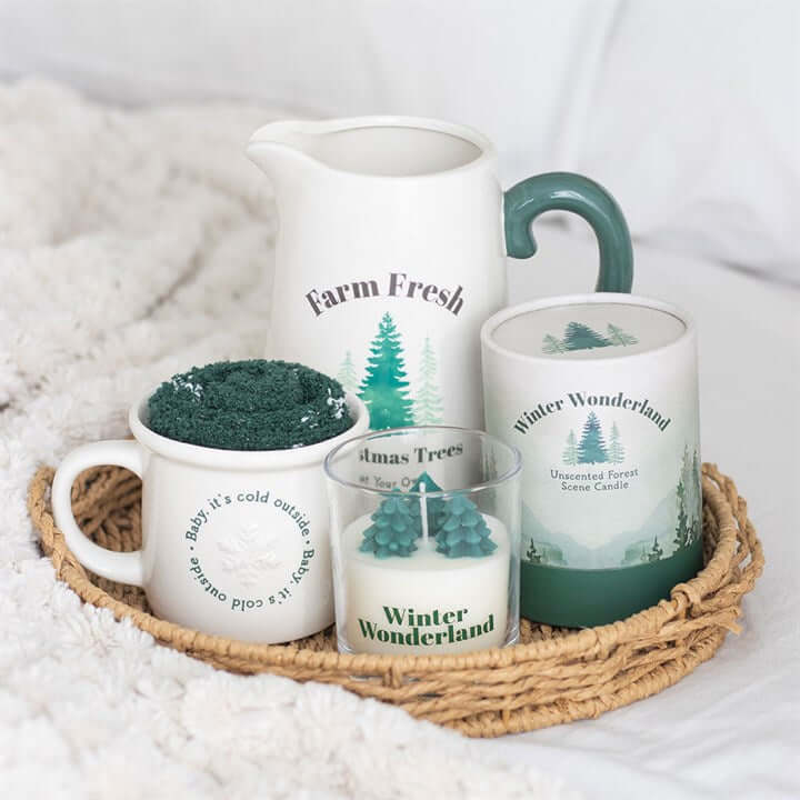 Winter Wonderland Candle with Tree Scene set: unscented ceramic jug, mugs and mini trees on a wicker tray.