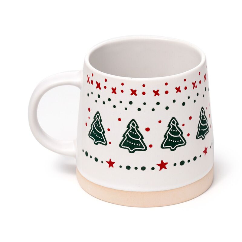Stoneware mug with Christmas tree pattern, white body, green trees, red dots and stars, beige base.