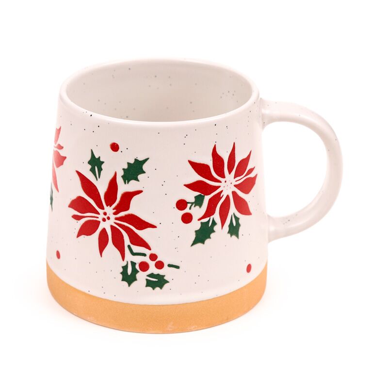 Stoneware mug with red poinsettia, holly leaves and berries on a speckled cream glaze, orange base.