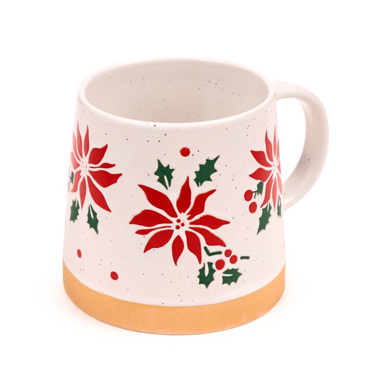 Stoneware mug with red poinsettia and holly, speckled white glaze and tan base.
