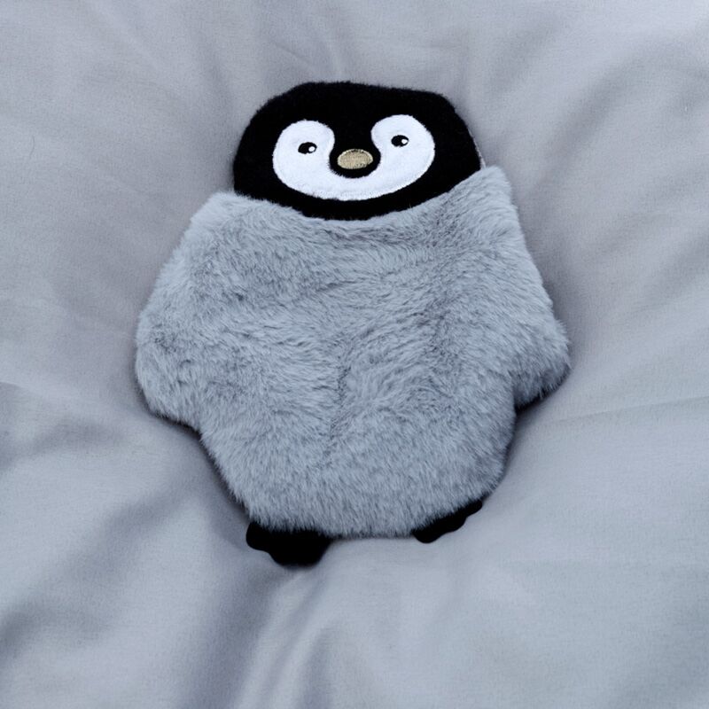 Penguin-shaped microwavable plush heat pack wrapped in soft grey fabric