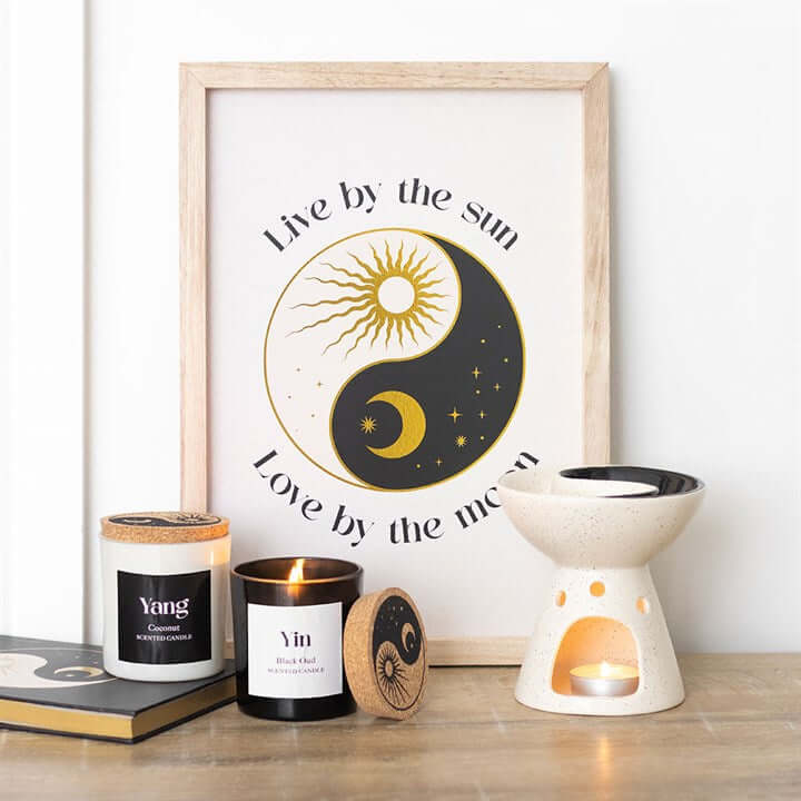 Set of 2 Yin Yang Black Oud and Coconut Candles displayed with a decorative frame and wax warmer, perfect for home balance.