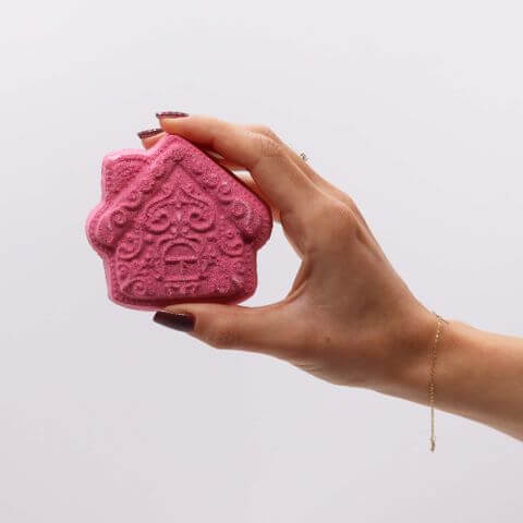 Handcrafted pink bath bomb shaped like a house from the Christmas Wish List Christmas Bath Bomb Gift Pack.