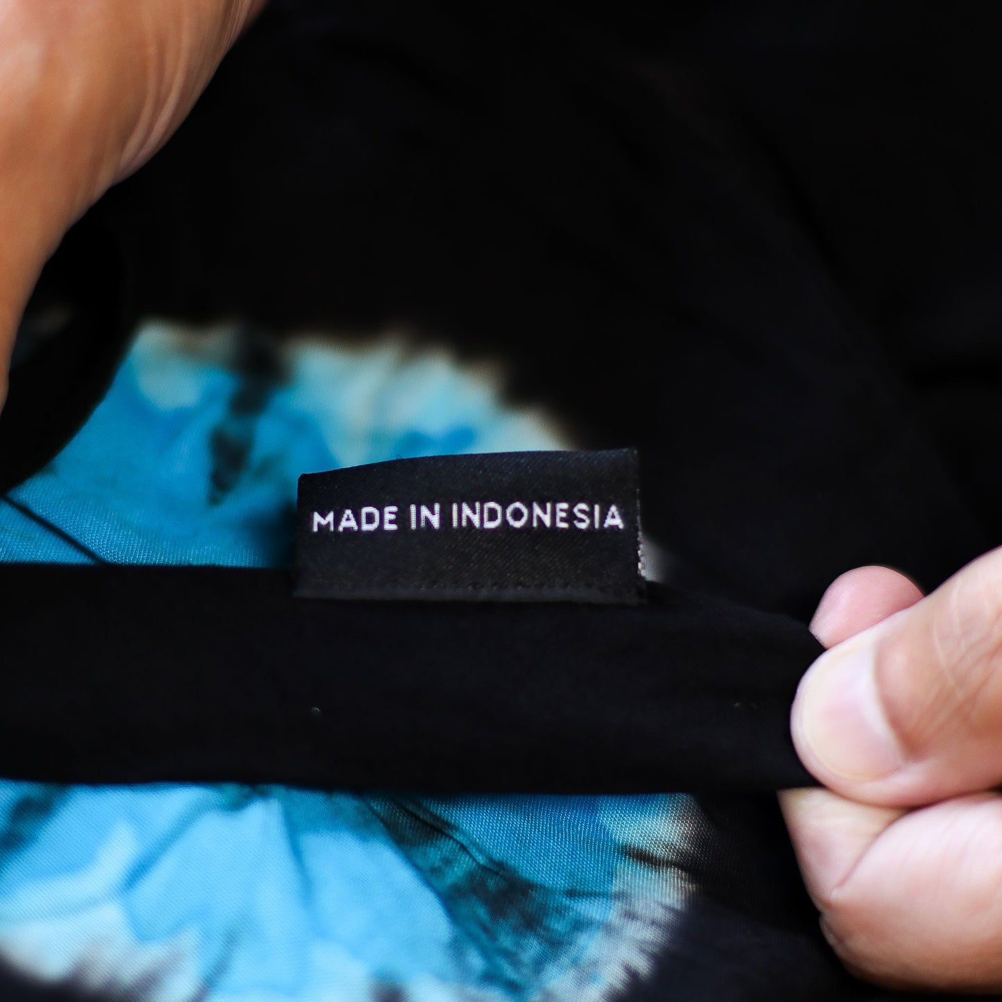 Close-up of Made in Indonesia tag inside Japanese style lounge pants with blue tie-dye lining.