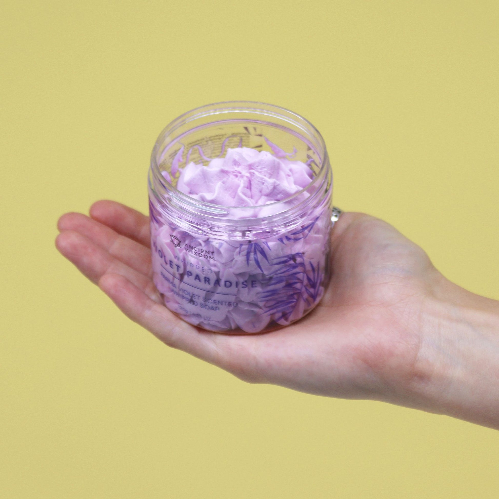 Parma Violet Whipped Soap 120g in clear jar, lilac whipped soap held in a hand.