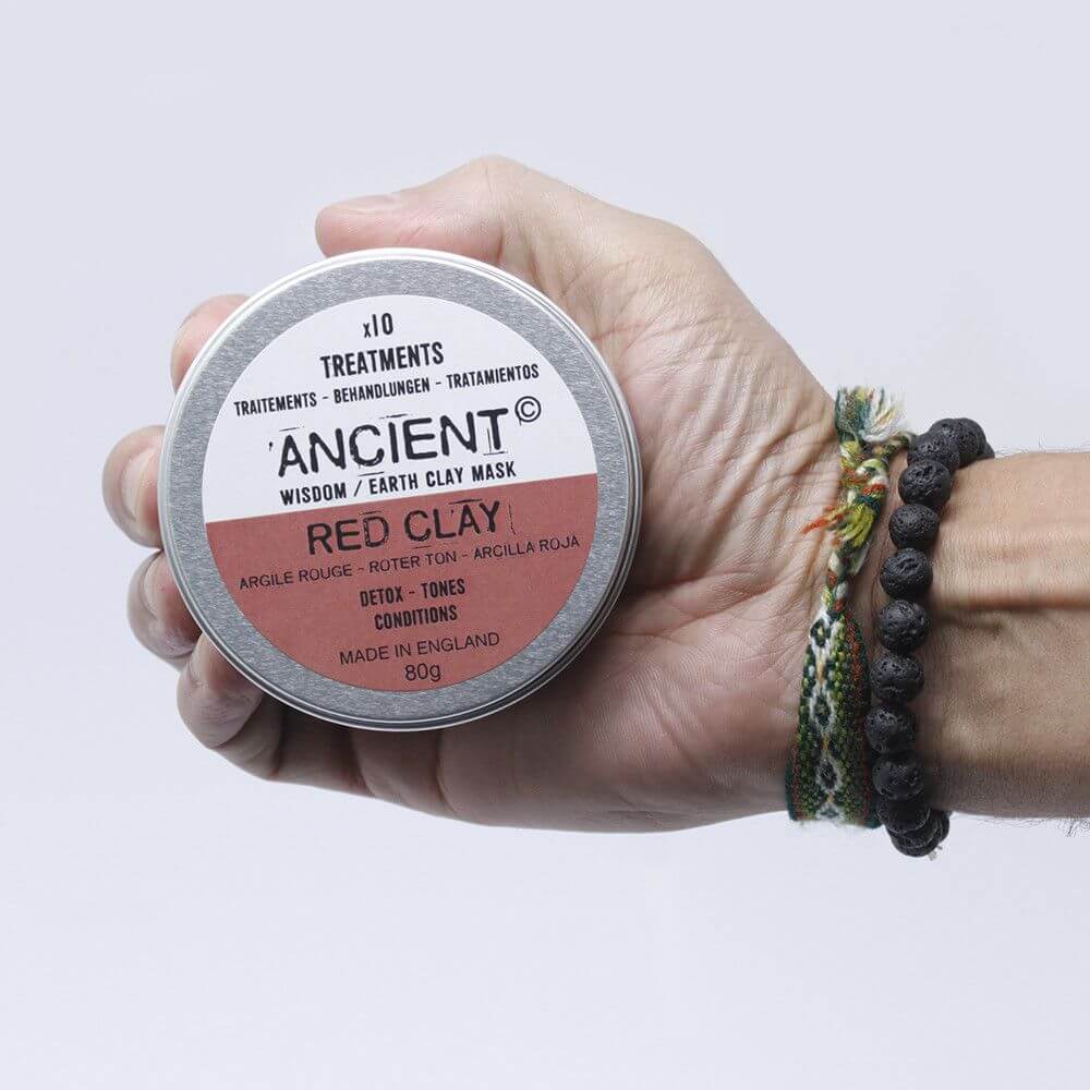 Red Clay Face Mask 80g by Ancient Wisdom, tin held in a hand with bracelets