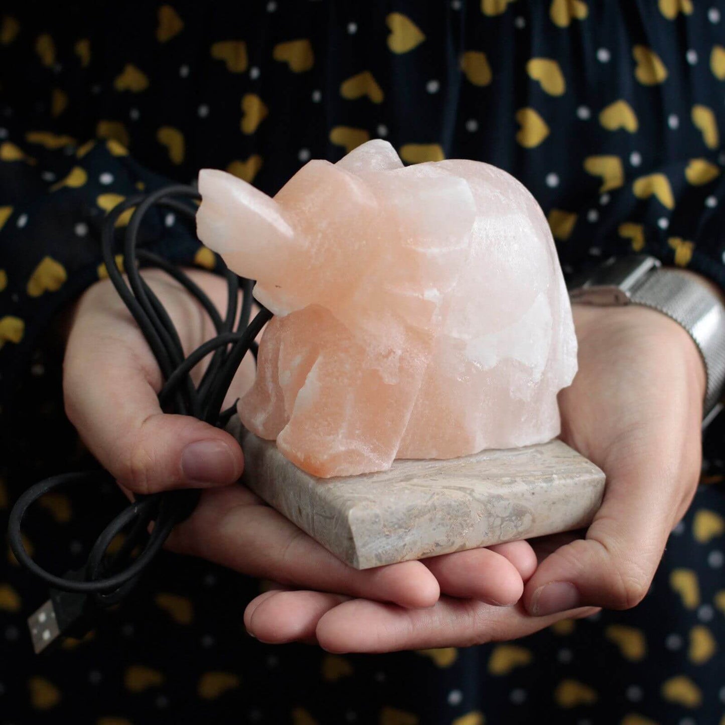 USB Elephant Shaped (Multi) Himalayan salt lamp with USB cable on a stone base, peach glow.