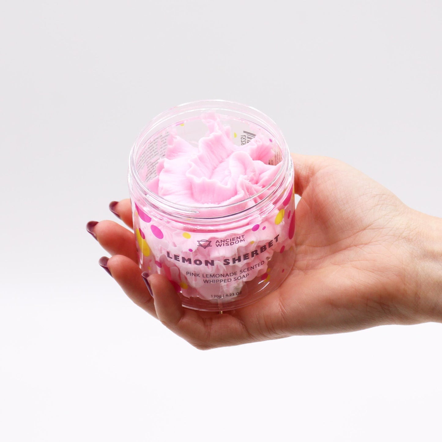 Pink Lemonade Whipped Soap 120g in clear jar with lemon sherbet scent, pink whipped soap swirls, held by a hand