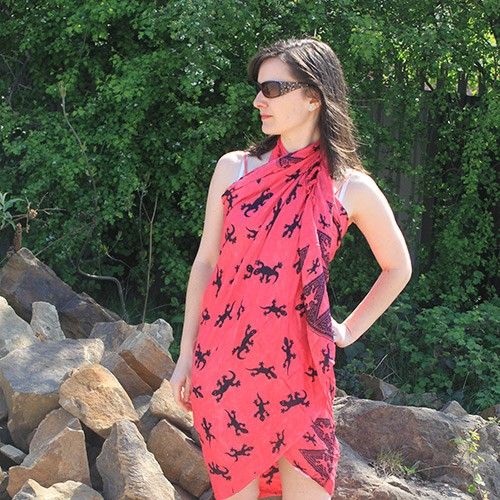 Charming Bali Gecko Sarongs - Pink, featuring a vibrant coral-pink base with playful gecko patterns and fringe trim.
