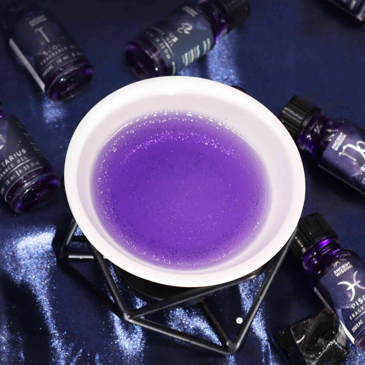 Zodiac Fragrance Oil 10ml - VIRGO in a bowl, featuring dark oil with bio glitter for a celestial essence.