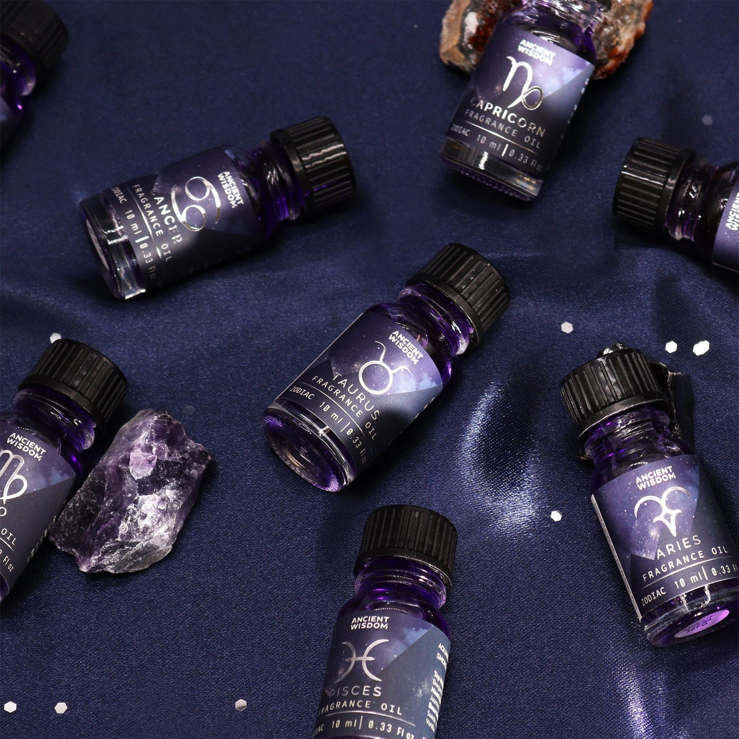Zodiac Fragrance Oil 10ml - VIRGO displayed among other zodiac oils, featuring enchanting dark-coloured oil with glitter.