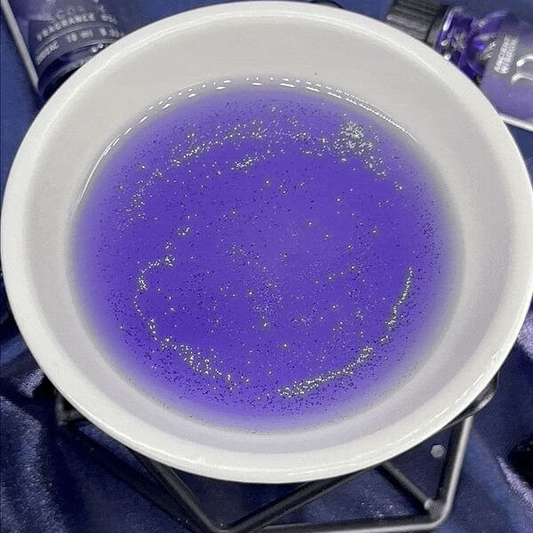 Zodiac Fragrance Oil 10ml - VIRGO in a bowl, featuring dark oil with bio glitter that sparkles beautifully.