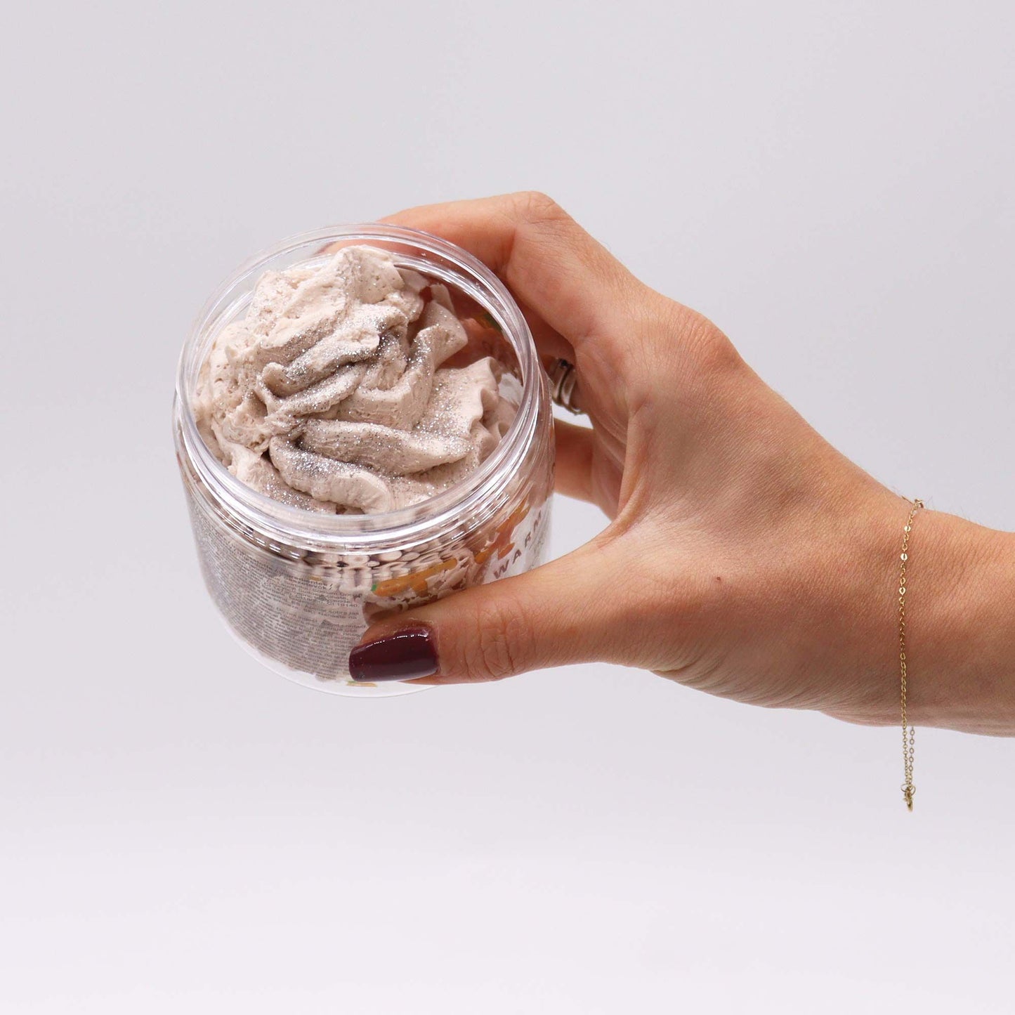 Warm Gingerbread Whipped Soap 120g jar with creamy swirls, held in a hand.
