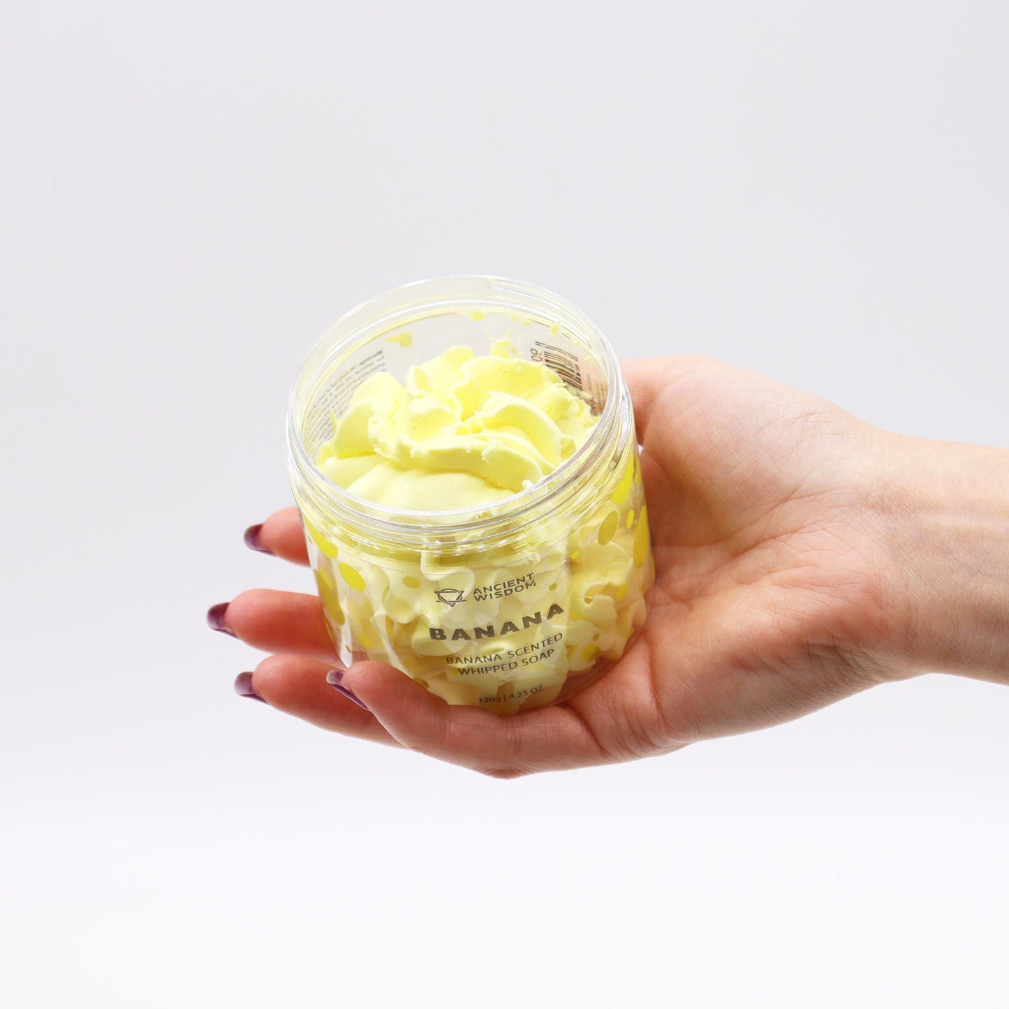 Banana Whipped Soap 120g in a jar, ripe banana scent, cruelty-free, vegan, paraben-free and SLS-free, held in hand.