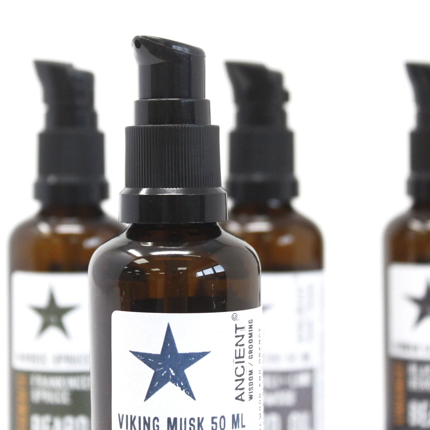 Amber beard oil bottles with black droppers; white labels feature a blue star and 'VIKING MUSK 50 ML'.