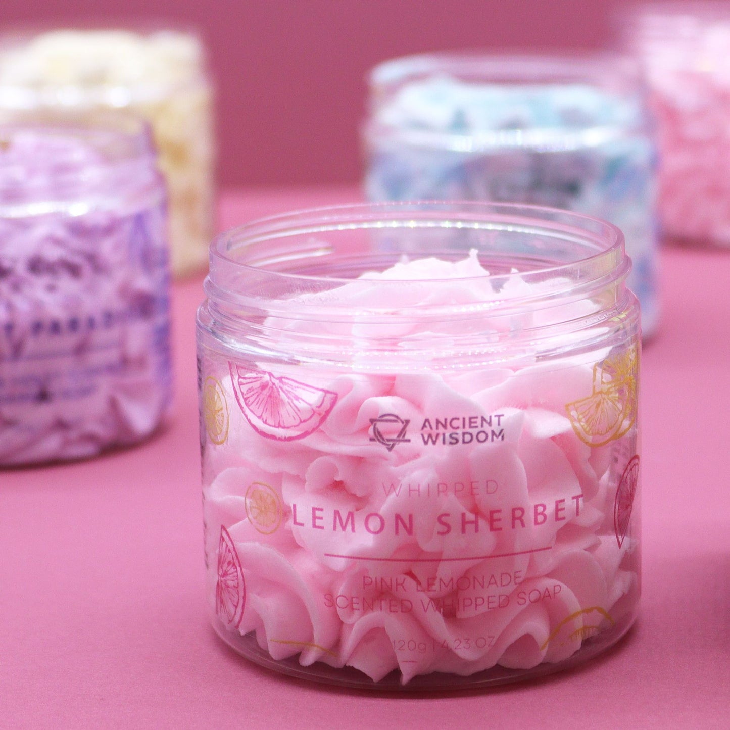 Pink Lemonade Whipped Soap 120g in a clear jar, lemon-sherbet swirls with lemon-slice illustrations on the label.