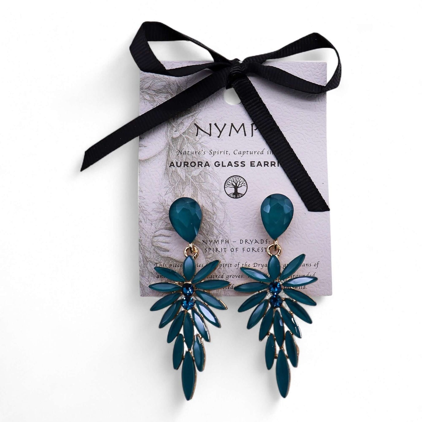 Teal green vintage glass long drop earrings with a leaf-and-flower cluster, on a lilac card with a black ribbon.