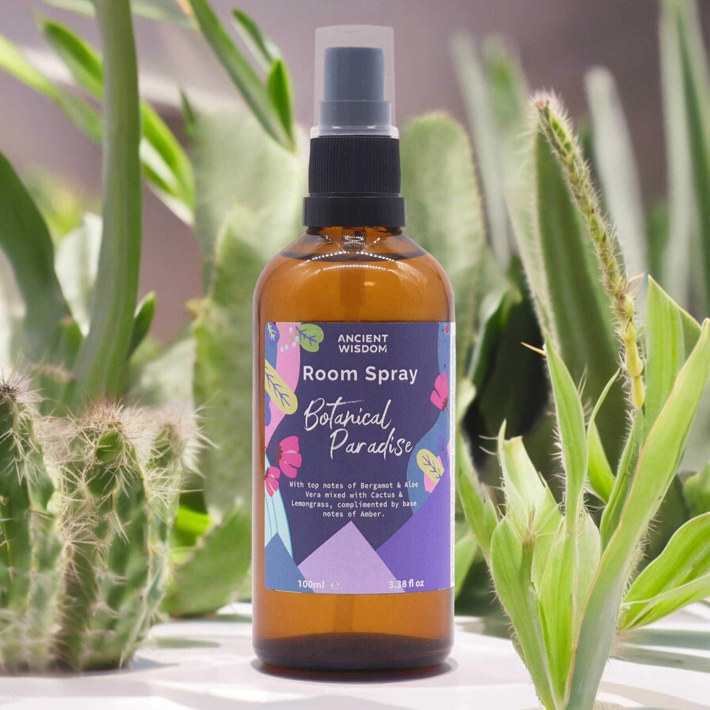 Ancient Wisdom Summer Room Spray - Botanical Paradise 100ml amber bottle with botanical label among green plants