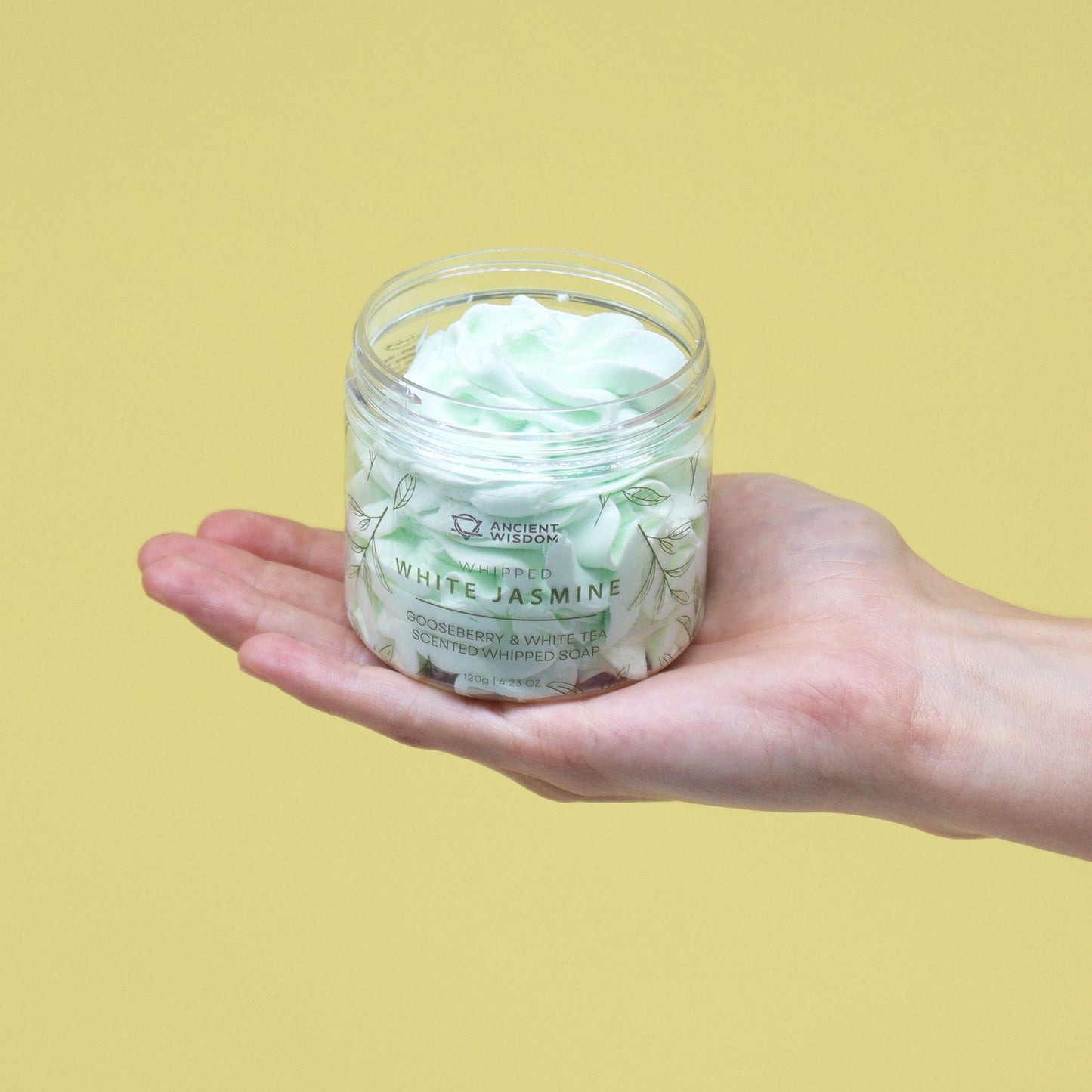 Gooseberry & White Tea Whipped Soap 120g with White Jasmine scent, held in a hand.