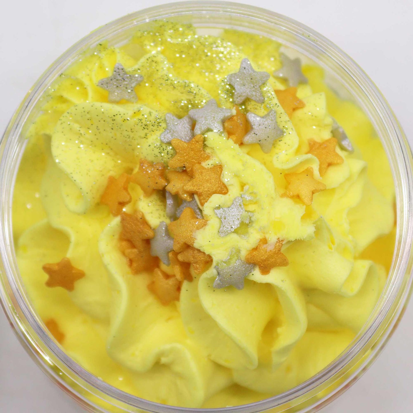 Cosy Winter Nights Whipped Soap 120g: bright yellow whipped soap in a tub with orange and silver star sprinkles.