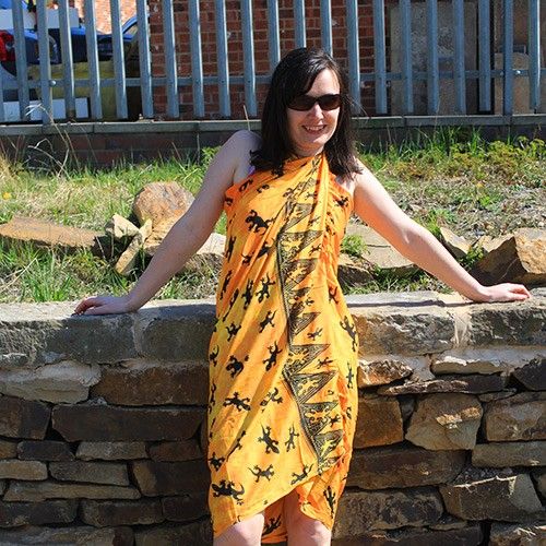 Bali Gecko Sarongs - Orange showcases a vibrant gecko pattern with fringe trim, perfect for a stylish bohemian look.