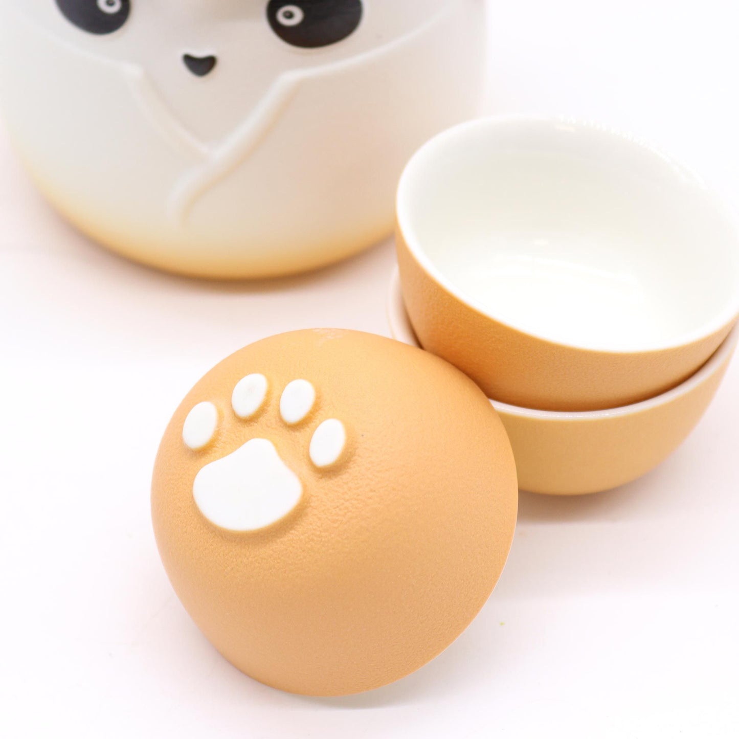 Panda Teapot Set with three orange cups, ceramic paw-print lid, perfect Panda Teapot Set for tea time.