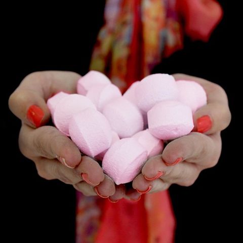 Soft pink mini bath bombs in hands, 1.3Kg Box of Chill Pills (Mini Bath Bombs) - Rose, perfect for gifts and favours.