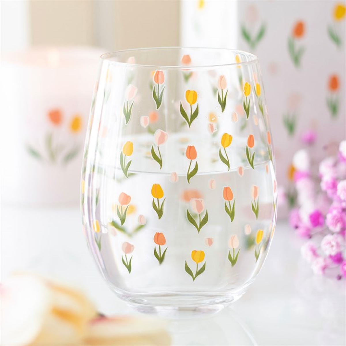Tulip print stemless glass with colourful tulips on clear glass, ideal for spring gatherings.