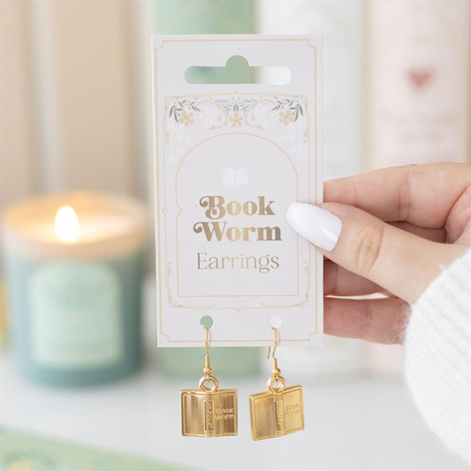 Book Worm Earrings: gold-tone book-shaped steel dangle earrings on ornate packaging, a literary fashion accessory.