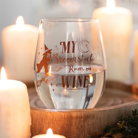 Stemless wine glass featuring a flying pin-up witch design and the slogan 'My Broomstick Runs on Wine'.