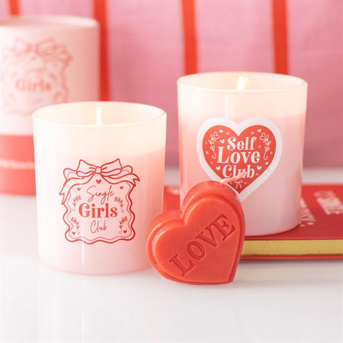 Red Love Heart Shaped Valentine's Day Candle displayed with pink candles for self-love and romance.