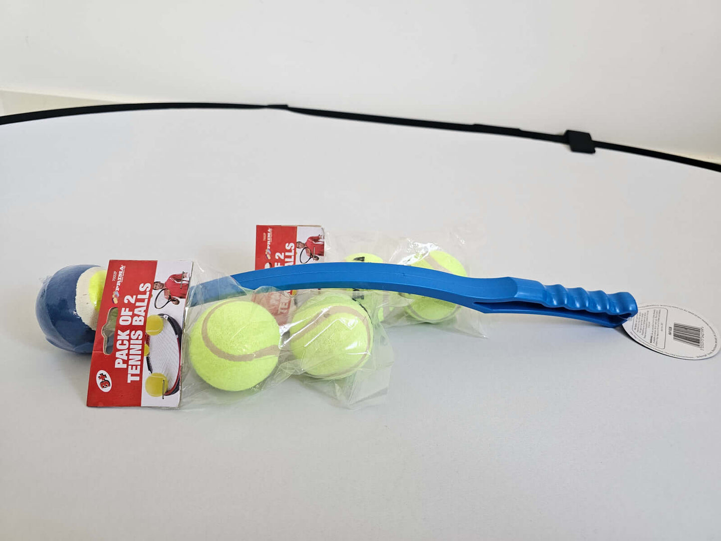 Tennis ball launcher and refill pack with blue handle and bonus tennis balls for extended fetch fun at Fetch!