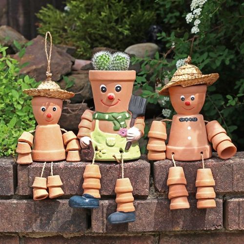 Small Terracotta Pot Man adds whimsical charm to your garden, perfect for hanging amidst plants and flowers.