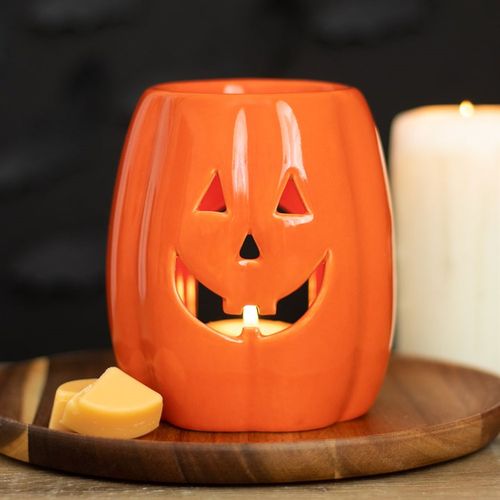Bright orange Jack-o'-Lantern Oil Burner and Wax Warmer, perfect for cosy autumn nights and Halloween festivities.