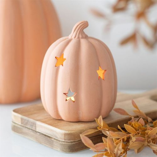 Charming 9cm Terracotta Pumpkin Tealight Holder with star cut-outs, perfect for autumn and Halloween decorations.