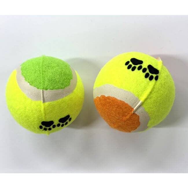 Two tennis balls with paw prints on a white background
