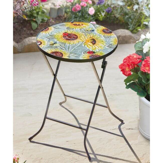Small round table with sunflower design on a patio