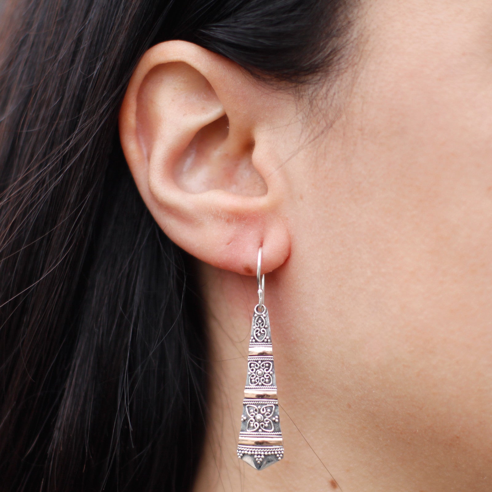 Handmade silver and 18ct gold tribal drop earrings, showcasing exquisite design and elegance. Perfect for any occasion.