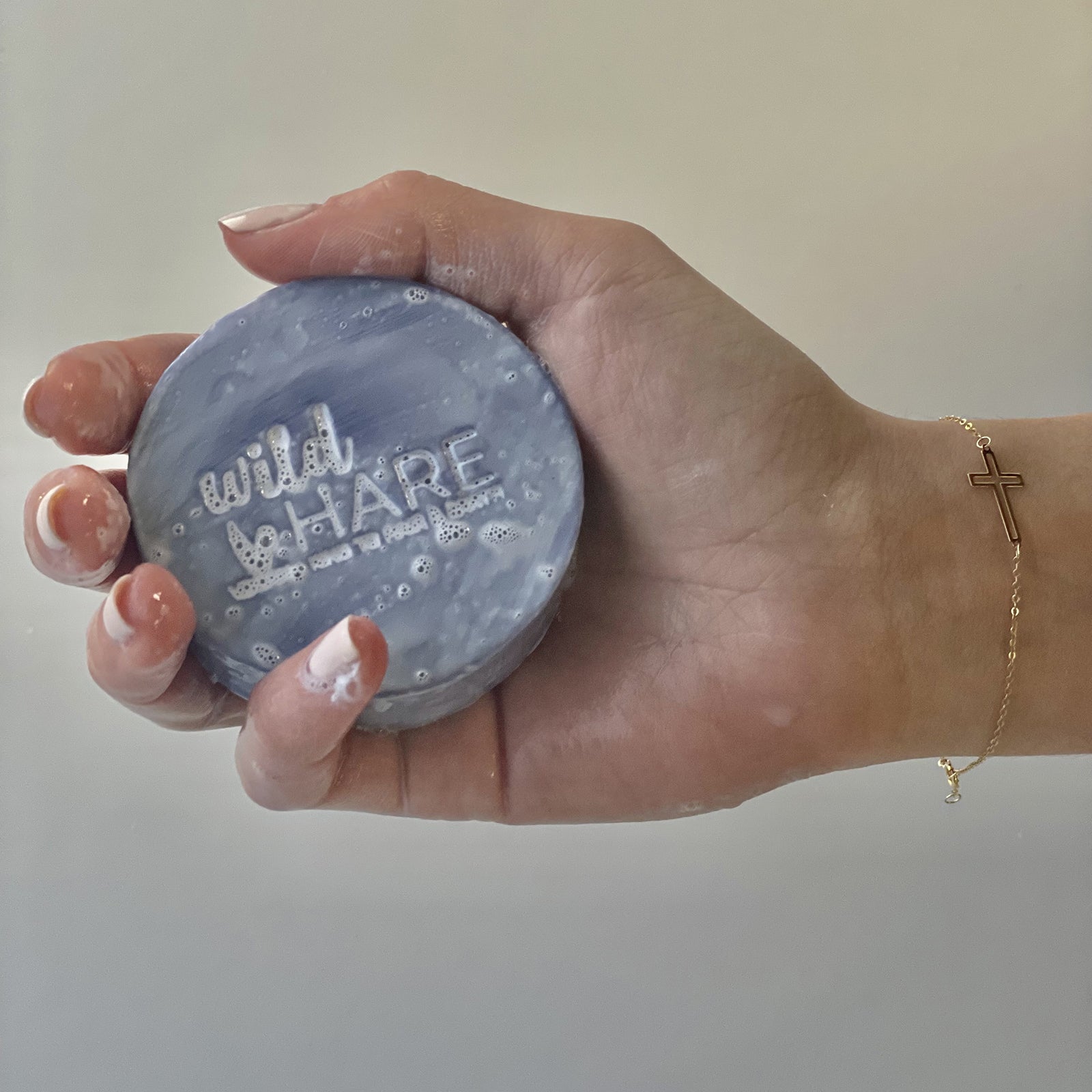 Wild Hare Solid Shampoo 60g Choose your Favourite in hand, showcasing its eco-friendly design and gentle lather.