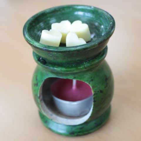 Aroma Wax Melts - Ylang Ylang in a green oil burner, creating a soothing aroma with heart-shaped wax melts.