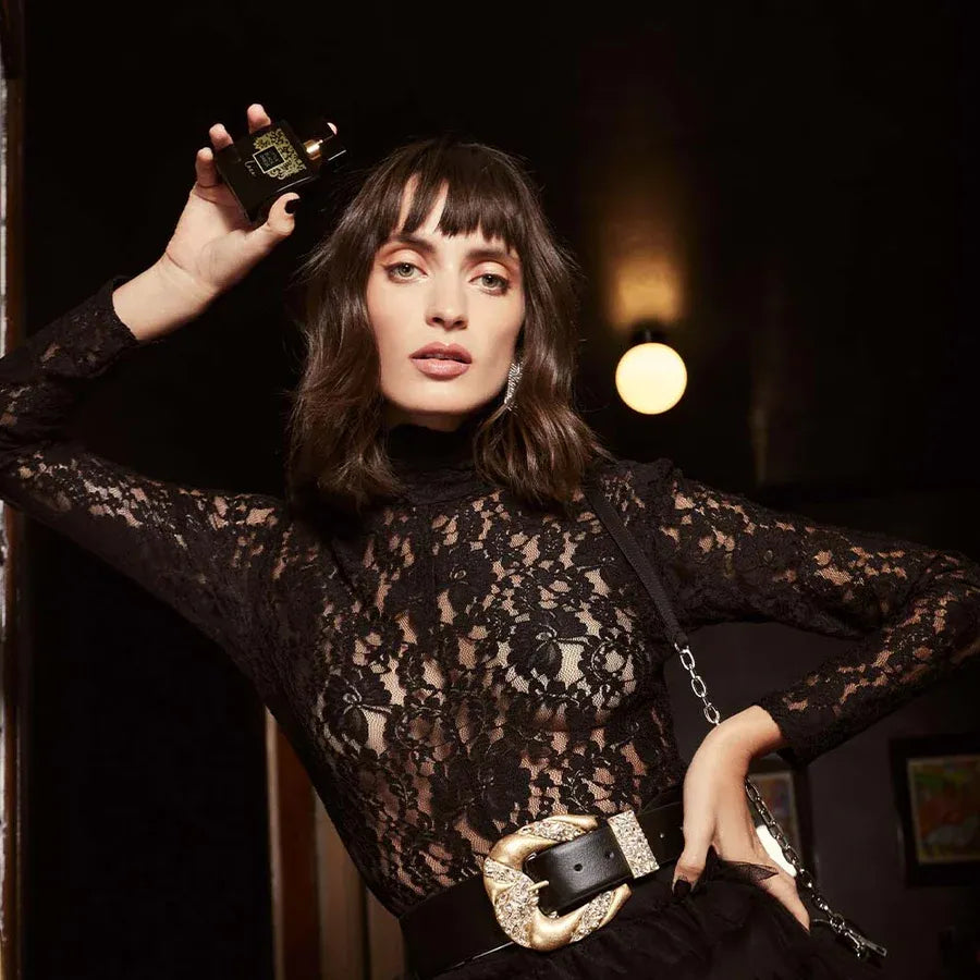 Sophisticated woman showcasing Avon Little Black Dress "Lace" EDP for Her, exuding elegance and allure in lace attire.