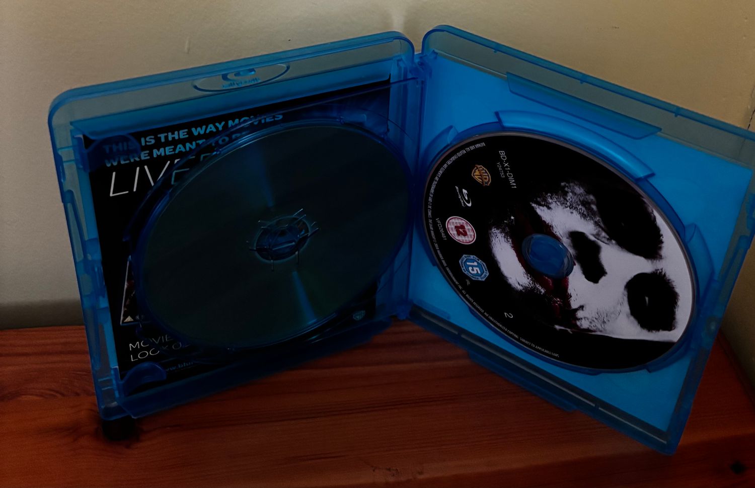 The Dark Knight Blu Ray in a blue case, showcasing thrilling action from Christopher Nolan's masterpiece.