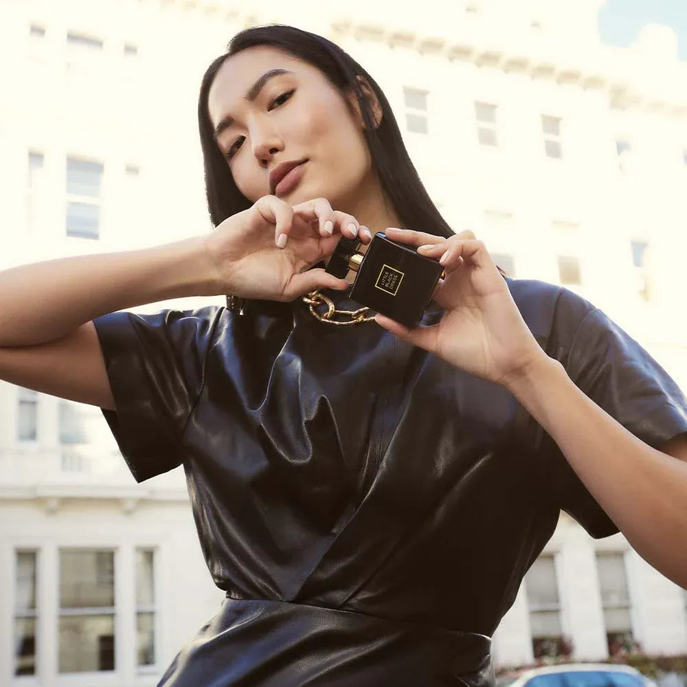 Elegant woman showcasing Avon Little Black Dress EDP Eau de Parfum 50ml, perfect for modern sophistication.